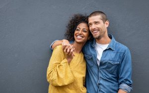 couple holding hands and smiling